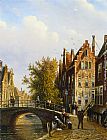A Dutch town with figures on a canal by Johannes Franciscus Spohler